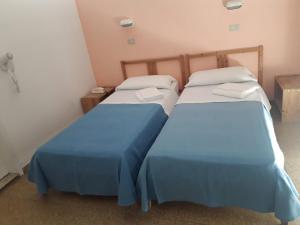 Posteľ alebo postele v izbe v ubytovaní Hotel Colombo