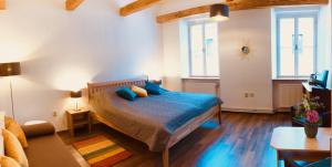a bedroom with a bed with blue pillows on it at Penzion Laterna in Litoměřice