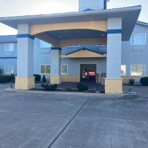 a large building with a parking lot in front of it at Super 8 by Wyndham Martinsville in Martinsville