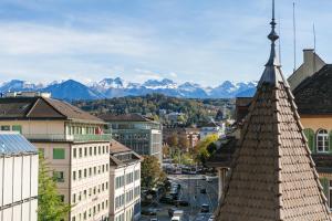 a view of a city with mountains in the background at AirHosted - Lucerne City Centre in Lucerne