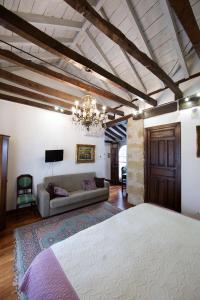 
a bedroom with a large bed and a large window at Hotel Boutique Nueve Leyendas in Úbeda
