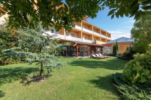 a large building with a lawn in front of it at Hotel Vital in Zalakaros