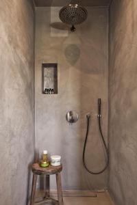 a bathroom with a shower with a stool in it at Luxury Naxos Villas Elegant Villa Air Conditioning Private Pool 4 Bedroom Stelida in Naxos Chora