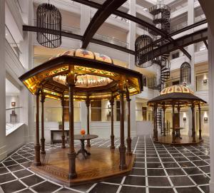 a building with two gazebos on a tiled floor at The Lalit Great Eastern Kolkata in Kolkata