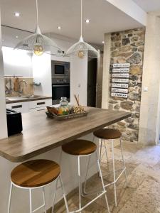 a kitchen with a large wooden counter with stools at mourillon in Toulon