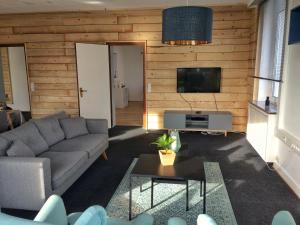 a living room with a couch and a tv at Ferienwohnung Stadtvilla in Bad Marienberg