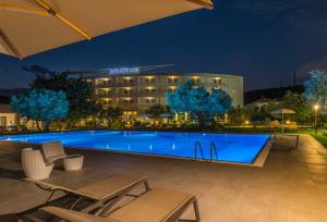 a hotel with a swimming pool at night at Rada Siri in Montepaone
