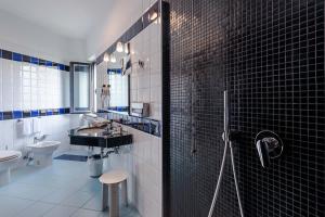 a bathroom with a sink and a toilet and a shower at Rada Siri in Montepaone