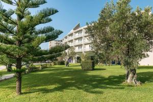 a park with trees in front of a building at Rada Siri in Montepaone