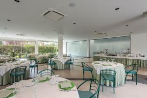 a dining room with white tables and chairs at Rada Siri in Montepaone