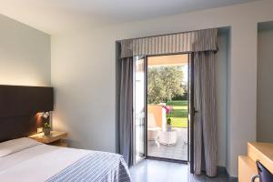 a bedroom with a bed and a sliding glass door at Rada Siri in Montepaone