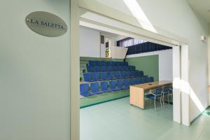 a conference room with blue chairs and a table at Rada Siri in Montepaone