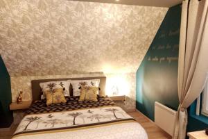 sypialnia z łóżkiem z palmami na ścianie w obiekcie L'Evasion... Balnéo. w mieście Sainte-Savine