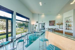 a bar with chairs and tables in a room at Rada Siri in Montepaone