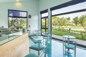 a bar with chairs and tables and a large window at Rada Siri in Montepaone