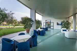 a restaurant with blue and white tables and chairs at Rada Siri in Montepaone