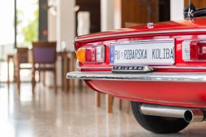 a red car with a license plate on the back at Ribarska Koliba Resort in Pula