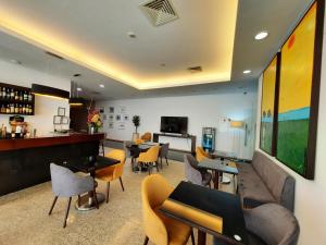 a bar with chairs and tables in a room at BejaParque Hotel in Beja