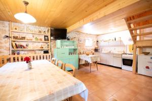 a kitchen with a table and a dining room at Miha lodge - Mihčevo pleče in Soča