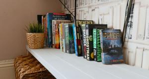 a shelf with a bunch of books on it at Midtown Lodge in Nottingham