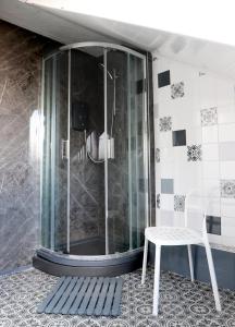 a shower with a white chair in a bathroom at Midtown Lodge in Nottingham
