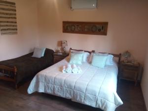 a bedroom with a bed with two towels on it at La Posada de Don Segundo in San Antonio de Areco