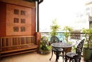 a patio with a table and chairs on a balcony at Bi Saigon Hotel in Ho Chi Minh City