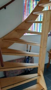 a wooden staircase with books in the background at Bed en Boterham in Hedel