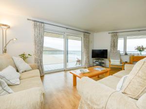 a living room with two couches and a large window at 17 Burgh Island Causeway in Kingsbridge