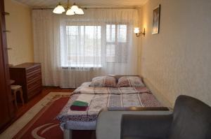 a small bedroom with a bed and a window at Квартира на Дарвина in Tver