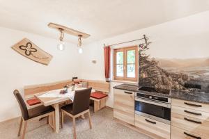 a kitchen with a table and a dining room at Ferienhaus Spitzenhof - Urlaub am Bauernhof in Mooslandl