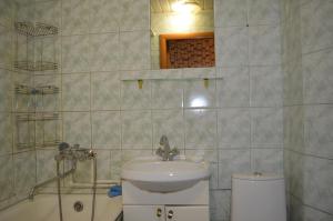 a bathroom with a sink and a toilet and a tub at Квартира на Дарвина in Tver
