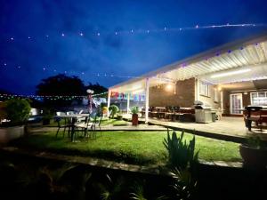 a patio with a table and chairs at night at Bed and Breakfast at Eves in Durban
