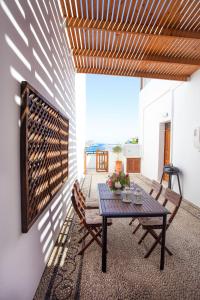 a dining room with a table and chairs on a patio at Sea View Villa Thea 3 in Rhodes Lindos in Lindos