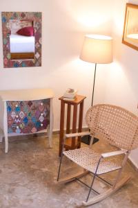 a room with a chair and a lamp and a bed at Sea View Villa Thea 3 in Rhodes Lindos in Lindos