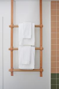 a towel rack in a bathroom with white towels at White Water in Cambria +39 photos