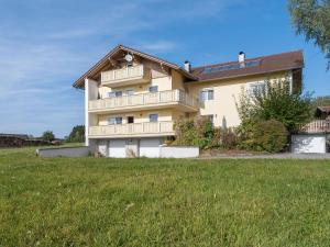 a large house with a lawn in front of it at Spacious apartment in the Bavarian Forest in Viechtach