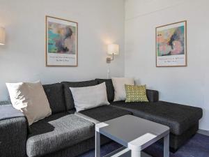 a living room with a couch and a table at 5 person holiday home in V ggerl se in Bøtø By