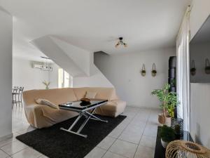 a living room with a couch and a table at Holiday home near beach with private pool in Pinet