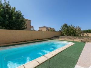 a swimming pool in front of a house at Holiday home near beach with private pool in Pinet