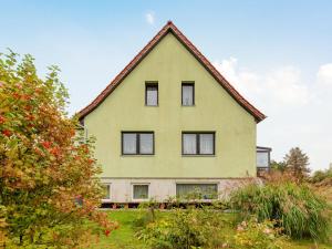 a yellow house with a gambrel roof at Pretty Farmhouse with Swimming Pool, Garden, Terrace, BBQ in Kröpelin