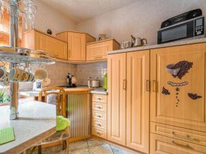 a kitchen with wooden cabinets and a counter top at Apartment in Ilsenburg near the ski area in Ilsenburg