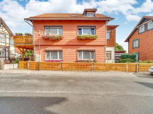 a house with a wooden fence in front of it at Apartment in Ilsenburg near the ski area in Ilsenburg