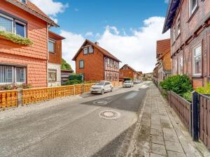 a street with houses and a car on the road at Apartment in Ilsenburg near the ski area in Ilsenburg