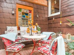 a patio with a table and chairs on a patio at Apartment in Ilsenburg near the ski area in Ilsenburg
