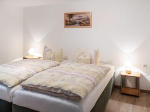 two twin beds in a room with two lamps at Scintillating Apartment in Wienrode near City Centre in Wienrode