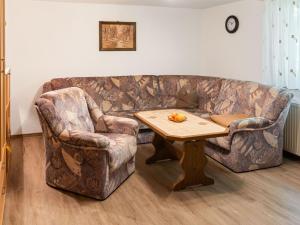 a living room with a couch and two chairs and a table at Scintillating Apartment in Wienrode near City Centre in Wienrode