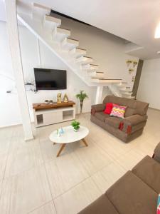 a living room with a couch and a table at Pousada Rekinty in Canindé de São Francisco