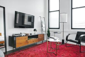 a living room with a flat screen tv on a wall at Abode Pittsburgh - Downtown Convention Center in Pittsburgh