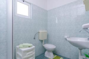 a bathroom with a toilet and a sink at Apartments Jaki - 150 m from beach in Orebić